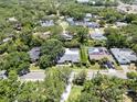 Aerial view of a neighborhood featuring lush greenery and well-maintained homes at 1810 Pine Hill Dr, Safety Harbor, FL 34695