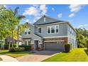 Charming two-story home with stone accents, lush lawn and manicured shrubbery at 19309 Prairie Tree Pl, Tampa, FL 33647