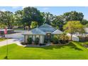 Charming single-story home with a landscaped yard, manicured bushes, and a concrete driveway at 22304 Stillwood Dr, Land O Lakes, FL 34639