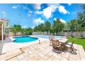 Relaxing backyard featuring a pristine pool with a jacuzzi and a delightful patio area at 2300 Hannah S Way, Dunedin, FL 34698