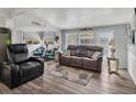 Bright and inviting living room with modern furniture, wood floors, and large windows at 2331 Belleair Rd # 214, Clearwater, FL 33764