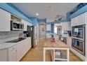Bright kitchen with white cabinets, stainless steel appliances, wood floors, and a butcher block island at 2510 Cross More St, Valrico, FL 33594