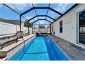 Inviting screened-in pool with a lounge chair for relaxing and enjoying the sun at 2510 Cross More St, Valrico, FL 33594