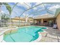 Backyard with a screened pool, spa, and seating area, perfect for outdoor relaxation and entertaining at 2706 Bent Leaf Dr, Valrico, FL 33594