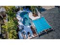 Aerial view of a backyard oasis featuring a sparkling pool, lounge area, and lush tropical landscaping at 330 47Th N Ave, St Petersburg, FL 33703