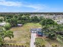 Sprawling aerial view showcasing the home's expansive yard, long driveway, detached garage, and surrounding neighborhood at 4125 89Th E St, Palmetto, FL 34221