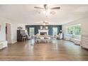 Spacious living room with fireplace, wood-look flooring, and bay window creating a bright and welcoming atmosphere at 4125 89Th E St, Palmetto, FL 34221