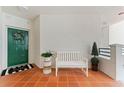 Charming entryway with a green door adorned with a wreath and a cozy bench for seating at 4750 Dolphin Cay S Ln # 209, St Petersburg, FL 33711