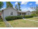 Quaint single-story home with a fenced yard and vibrant green bushes, offering a welcoming and private curb appeal at 5148 3Rd N Ave, St Petersburg, FL 33710