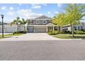 Charming two-story home with a three-car garage, well-manicured lawn, and inviting curb appeal at 5809 Alabaster Stone Ln, Apollo Beach, FL 33572