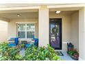 Inviting front porch featuring cozy seating, a decorative wreath, and a welcoming entrance at 626 Diamond Ridge Rd, Seffner, FL 33584