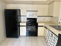Efficient kitchen featuring black appliances and ample cabinet space at 6304 Pointe West Blvd # A206, Bradenton, FL 34209