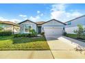 Charming single-story home with a well-manicured lawn and a two-car garage at 6426 Bradford Woods Dr, Zephyrhills, FL 33542