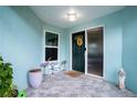 Welcoming front porch featuring decorative accents and a secure front door entrance at 6513 14Th W Ave, Bradenton, FL 34209
