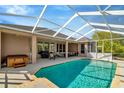 Screened-in pool with a spacious patio area for dining and relaxing, great for outdoor entertainment at 7051 Derwent Glen Cir, Land O Lakes, FL 34637