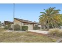 Charming home featuring a large garage, well-maintained landscaping, and a beautiful palm tree at 7509 Rocky Point Dr, Hudson, FL 34667