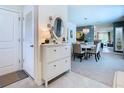 Bright foyer with a console table, decorative mirror, and views of the dining room at 7737 Sail Clover Ln, Zephyrhills, FL 33540
