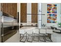 Modern kitchen with stainless steel refrigerator, island with seating and open floorplan at 88 Avonwood, Tampa, FL 33625