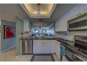 This kitchen has all white cabinets, black countertops and stainless steel appliances at 11590 Shipwatch Dr # 342, Largo, FL 33774