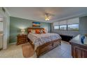 Large main bedroom features an expansive bed, dresser, end tables and views at 11590 Shipwatch Dr # 342, Largo, FL 33774