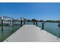 Close-up view of a private boat dock showcasing the dock's construction and the beautiful waterfront scenery at 14043 E Parsley Dr, Madeira Beach, FL 33708