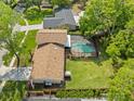 Aerial view of the home showing a screened pool, spacious backyard, and the surrounding neighborhood at 16320 Bonneville Dr, Tampa, FL 33624
