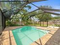 Beautiful screened-in pool area, perfect for relaxation and entertainment in a private backyard at 16320 Bonneville Dr, Tampa, FL 33624
