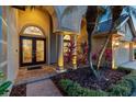 Stately front entrance featuring decorative glass double doors and landscaped columns at 26920 Winged Elm Dr, Wesley Chapel, FL 33544