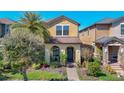 Inviting two-story home featuring a cozy front porch and well-maintained landscaping at 28642 Tranquil Lake Cir, Wesley Chapel, FL 33543