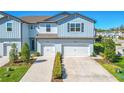 Charming two-story townhouse with attached garages and landscaped front yards at 2895 Deer Pine Trl, Land O Lakes, FL 34638