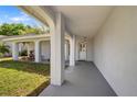 Welcoming front porch with brick pillars, offering a shaded entrance to the home at 3948 Tarpon Pointe Cir, Palm Harbor, FL 34684