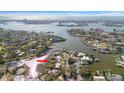 Stunning aerial view showcases waterfront property with deep canal access and lush landscaping at 4036 Church Creek Pt, Largo, FL 33774