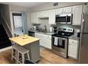 Bright kitchen with stainless steel appliances, island, and convenient in-unit laundry at 4201 La Palma Ct, Tampa, FL 33611