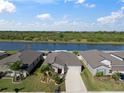 Aerial view of home backing up to a lake, and showcasing waterfront property at 5425 Rainwood Meadows Dr, Apollo Beach, FL 33572