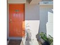 View of the home's bright orange front door and address number at 5425 Rainwood Meadows Dr, Apollo Beach, FL 33572
