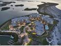 Stunning aerial view of luxury condominiums surrounded by water and lush landscaping at dusk at 755 Collany Rd # 504, Tierra Verde, FL 33715