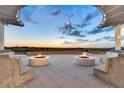 Beautiful sunset view from outdoor lounge area with modern fire pits and comfortable seating, ideal for evening relaxation at 755 Collany Rd # 504, Tierra Verde, FL 33715