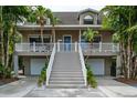 Inviting two-story home with a welcoming front porch, two-car garage, and easy access at 758 Claudia Ln, Palm Harbor, FL 34683