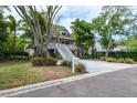 Charming two-story home with a spacious porch and well-maintained landscaping at 758 Claudia Ln, Palm Harbor, FL 34683