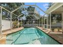 A screened-in pool and spa with stone surround, providing a private outdoor oasis at 7606 S Sparkman St, Tampa, FL 33616