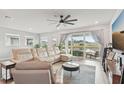 Airy living room featuring a comfortable sectional sofa and large windows overlooking the backyard at 8706 Arrow Creek Dr, Parrish, FL 34219