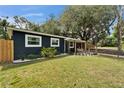 Detailed exterior view highlighting the dark stucco, manicured landscaping, and bright window trim at 901 King St, Plant City, FL 33563