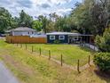Landscaped yard with a charming exterior view showcasing the home's setting and neighborhood at 901 King St, Plant City, FL 33563