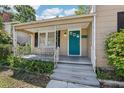 Home featuring a cozy front porch with a swing, offering a relaxing outdoor space at 933 E Shadowlawn Ave, Tampa, FL 33603