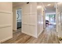 Well-lit hallway showcasing wood-look flooring and access to a modern bathroom at 1111 N Bayshore Blvd # E3, Clearwater, FL 33759