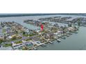 Aerial view of the home in a waterfront community with boat docks and stunning water views at 11755 7Th E St, Treasure Island, FL 33706
