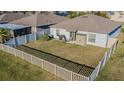 An enclosed backyard featuring a well-maintained lawn, patio furniture, and privacy fence at 12639 Lemon Pepper Dr, Riverview, FL 33578