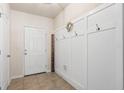 Welcoming entryway featuring a coat rack and tiled flooring at 14426 Haddon Mist Dr, Wimauma, FL 33598