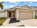 Charming single-story home featuring a two-car garage and well-maintained lawn in a desirable neighborhood at 14426 Haddon Mist Dr, Wimauma, FL 33598