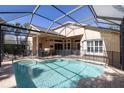 Backyard featuring a private screened-in pool with safety fence, outdoor ceiling fans, and patio furniture at 14809 Tudor Chase Dr, Tampa, FL 33626